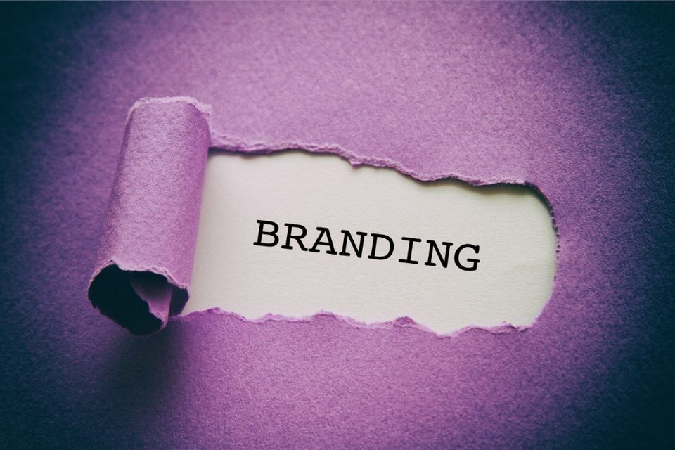 Purple construction paper torn away with the word 'branding' underneath